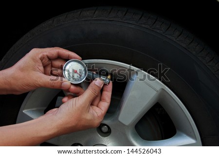 Tire pressure check by car mechanic outdoor