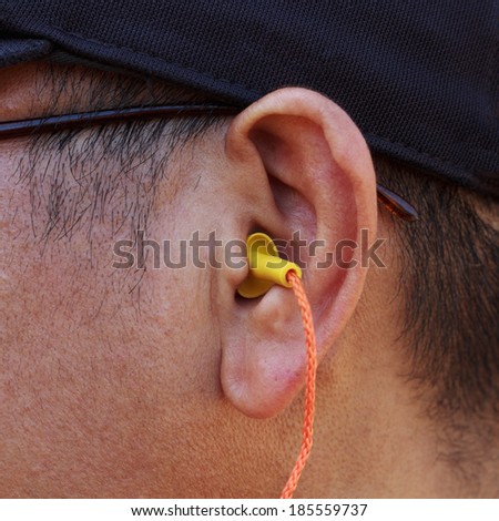 yellow ear plug into the ear.
