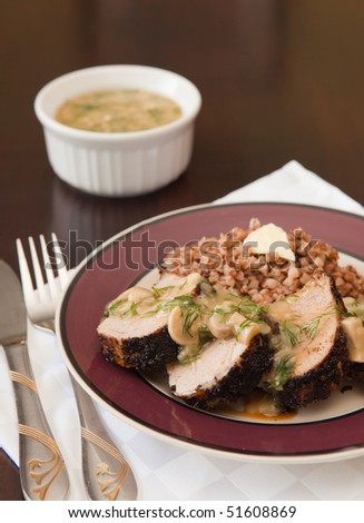 Pork roasted in spices with mushroom sauce and buckwheat