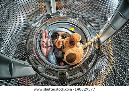 Hippie into a washing machine with glasses, flowers, peace symbol, dog and flute