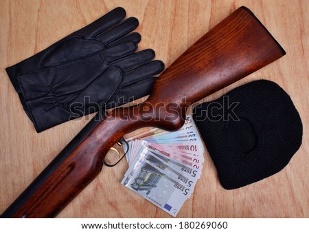 Things bandit criminal gun, balaclava, gloves, euro money  on the table