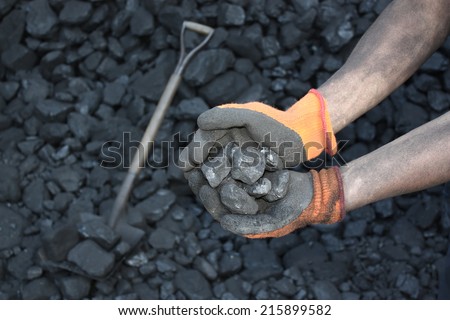 Coal miner holding a stone