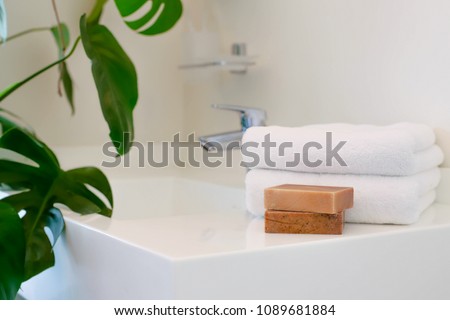 Handmade soap and clean towels in the bathroom. Copy space