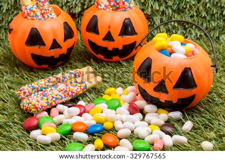 a halloween candy with pumpkin jack on grass background for halloween use (selective focus technique applied)