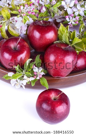 apples in a bowl with apple flower on a white background