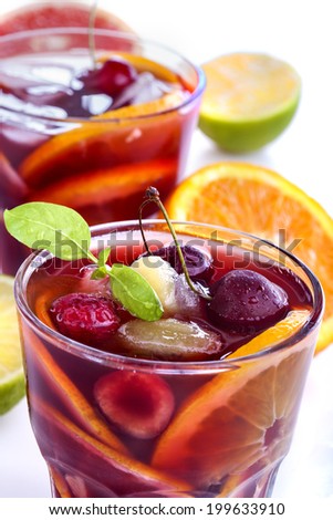 Sangria with citrus and other fruit on a white background