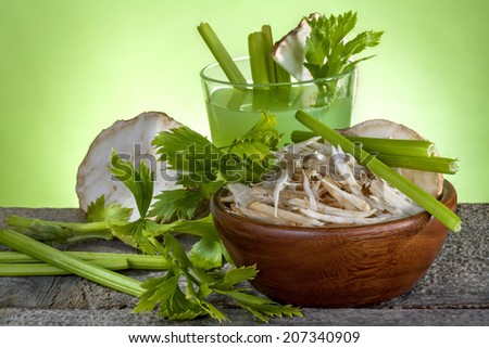 Celery salad with celery juice on a wooden table
