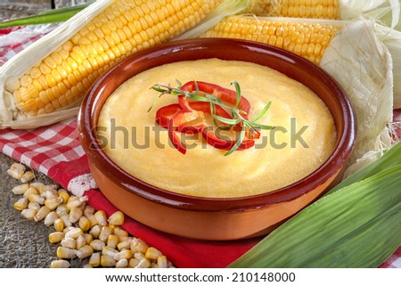 corn grits polenta in a bowl on old wooden table