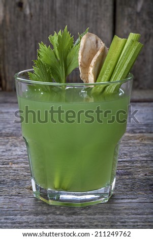 Healthy domestic celery juice on a wooden table