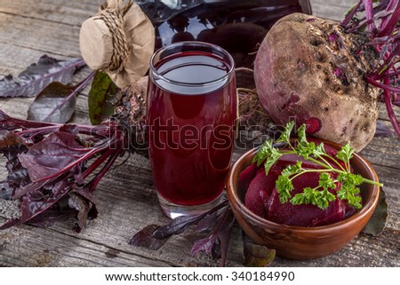 freshly squeezed juice of beetroot on an old wooden table