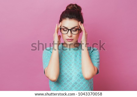 Close up isolated portrait of young stressed angry woman holding hands on head. Negative human emotions, headache face expressions. Lifestyle Fashion Beauty People Business concepts.