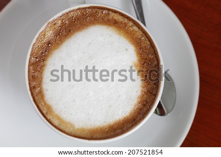 A Latte Coffee with swirls of creamy milk and espresso.