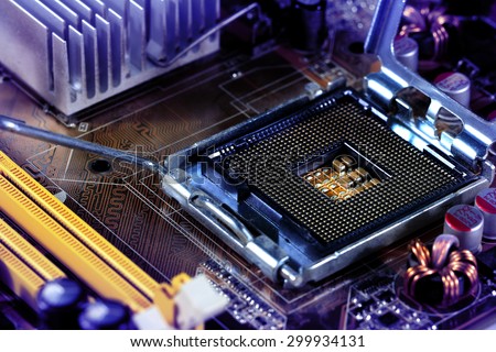 Empty CPU processor socket with pins on motherboard toned blue