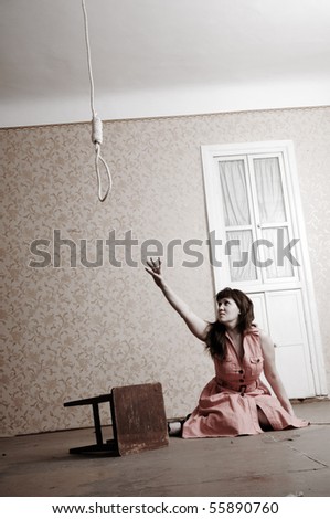 Middle aged  woman trying to make away with herself sitting alone on the floor of empty room.