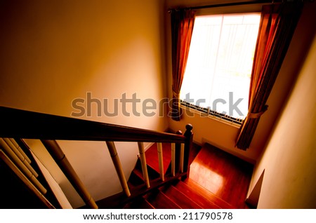Way down the dark stairs scary with light window and curtains. Dark and retro style