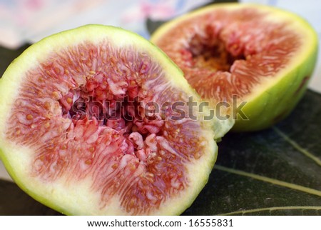 Halved Fresh fig on fig leaf close-up