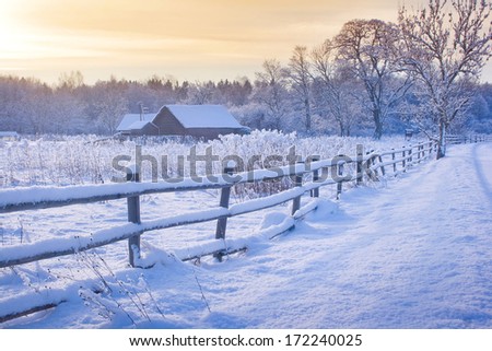 Rural House With A Fence In Winter