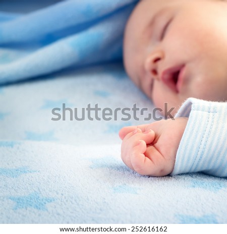3 month old baby sleeping on blue blanket