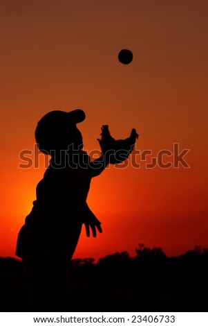 Silhouette of Young Boy Playing Baseball