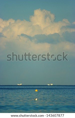 Boat pattern with big cloud in ocean