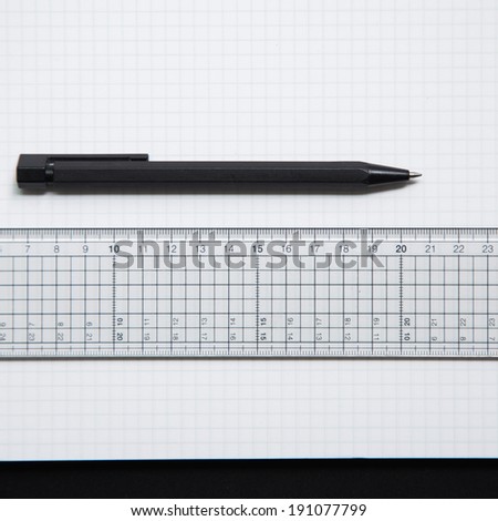 Pen and ruler on grid paper