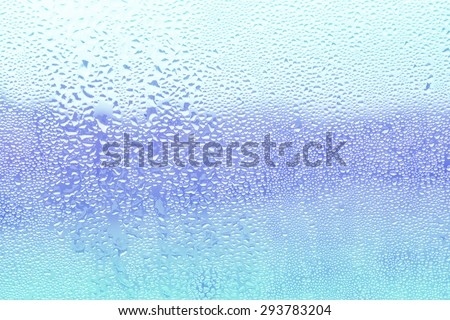 Drops Of Rain On Blue Glass Background. Background Out Of Focus.