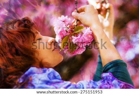 Beautiful Girl with flowers, Spring Magic. Sakura pink flowers.