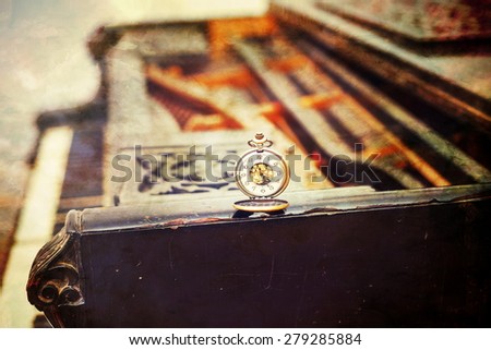 Vintage piano keys with antique pocket watch Ã¢?? time concept. vintage picture.