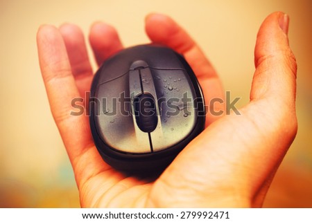 Open Hand and computer mouse  with water drops. Vintage picture