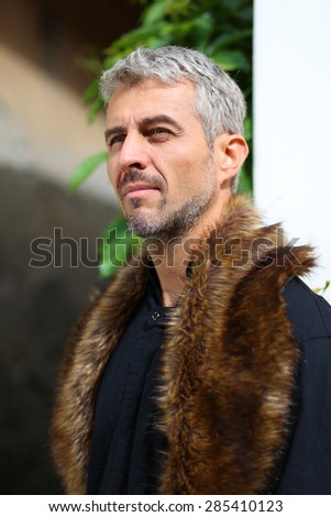 Portrait of a sexy man in wolf  fur, Looking out into the distance