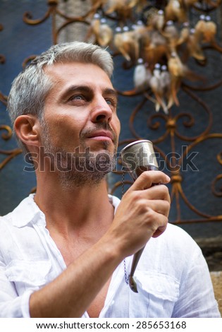 Man drinking beer  and medieval mead horn in hand. Toast concept
