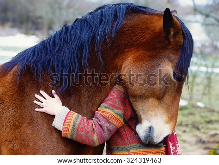 Portrait woman and horse in outdoor. Woman hugging a horse