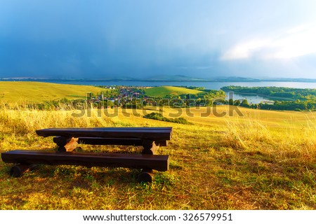 Beautiful landscape, green and yellow meadow and lake with mountain in background. Slovakia, Central Europe