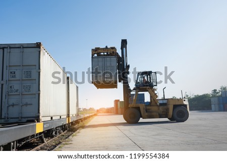 forklift working in the container cargo yard port loading cargo tank to the train.