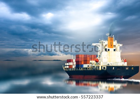Container ship in ocean on storm sky / selective focus.