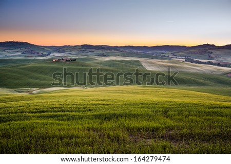 Sun rises over the fields in Tuscany