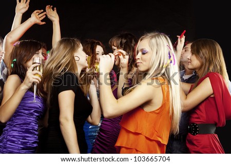 A group of young beautiful people dancing at a disco.