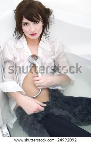 Portrait of a young woman lying at jeans in water