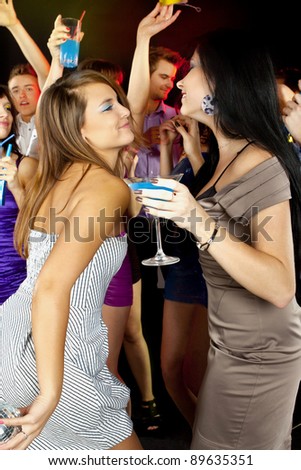 A group of beautiful young woman enjoying cocktails at party