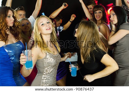 A group of young beautiful people dancing at a disco. New Year