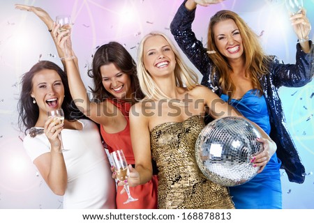 A group of young people dancing at night club. New Year party