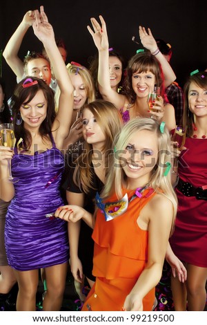 A group of young beautiful people dancing at a disco. New Year