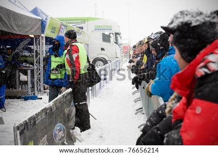 HAGFORS, SWEDEN - FEB 10: Crowd and press waiting for Ken Block to arrive at the service during WRC event Rally Sweden 2011 in Hagfors, Sweden on February 10, 2011