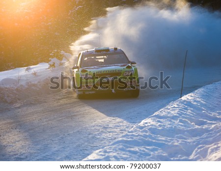 HAGFORS, SWEDEN - FEB 13: Mikko Hirvonen drifting his Ford Focus WRC rally car during Rally Sweden 2010 in Hagfors, Sweden on February 13, 2010