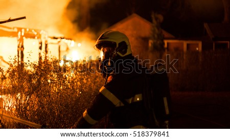 House Burning Down With Firefighter