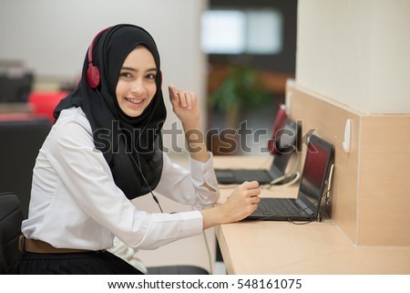 Muslim student girl using online education service. Young woman watching training course. Modern study technology.