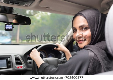 Muslim women driving car.
