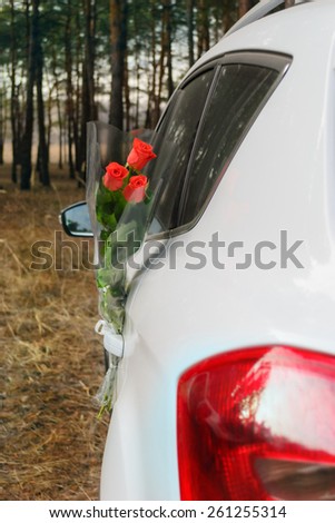 Bouquet of roses in car door