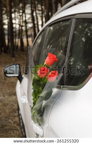 Bouquet of roses at car door