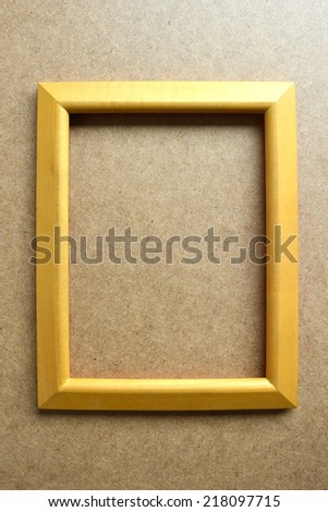 Wooden picture frame on wooden background.